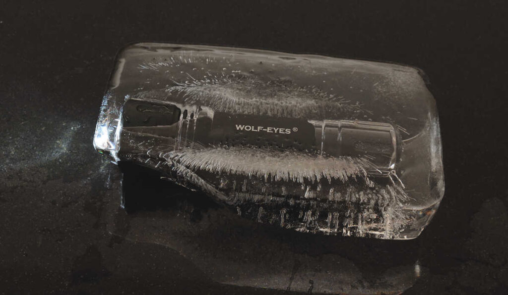 Sn1per II Pro Ultra Rechargeable LED torch in an ice block showing durability